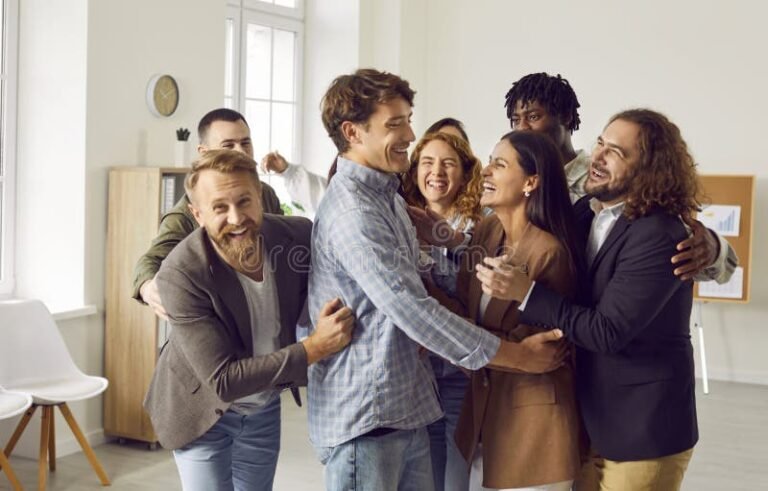 hymyilevat kollegat seisovat yhdessa juhlatilassa