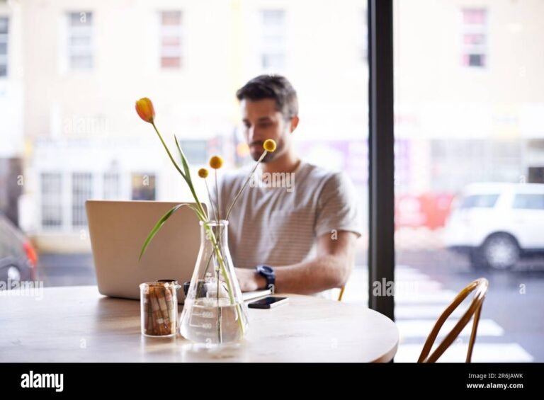 ihminen tyostamassa koodia kahvilassa