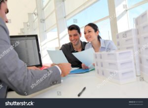 kaksi ihmista allekirjoittamassa lainasopimusta yhdessa