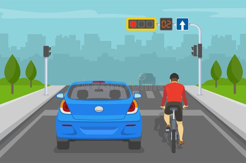 pyorailija ja auto liikennevaloissa